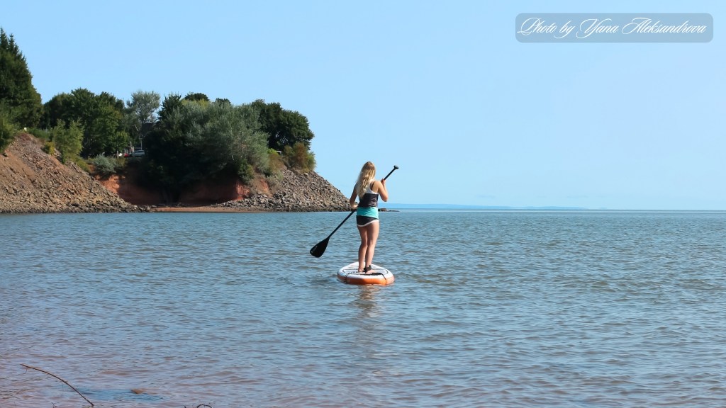 Paddle boarding at Kingsport Beach at high tide, Nova Scotia, Canada photo